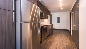 a kitchen with stainless steel appliances and wooden cabinets